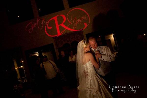 Couple dancing with monogram in background