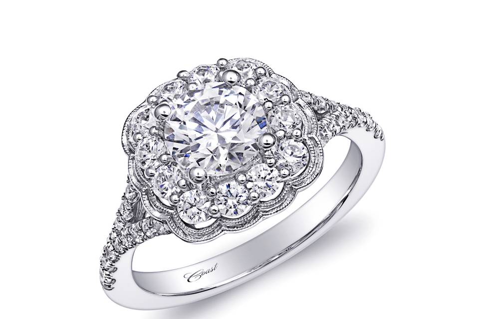 Style Engagement Ring (LC6026) <br> This striking floral inspired halo features an intricate row of fishtail diamonds on the shank, and is adorned with a milgrain edging on the halo. Shown with a 1 CT center stone (sold separately). Available in center stone of your choice.