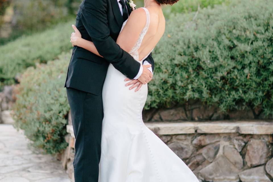 Quail Ranch wedding bride and groom kissing at QuailRanch Bride is wearing a Monique Lluillier Dress