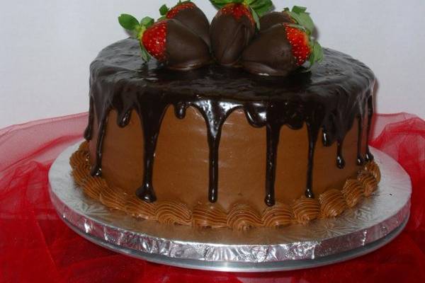 Triple chocolate Groom's cake with Dipped Strawberries.  Ganache covers the top and spills over the sides for a decorative touch.