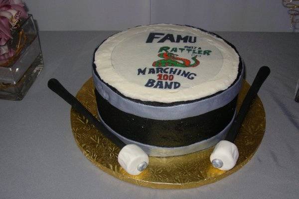 Grooms cake of bass drum and mallots.  Made for a groom who was in the marching band at FAMU, edible image portrays their logo.