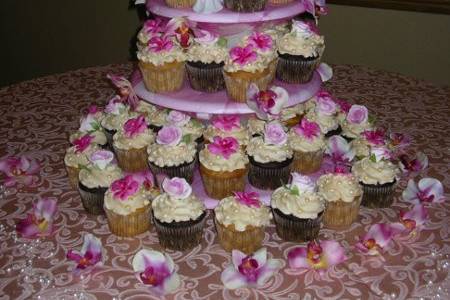 Cupcake Wedding Cake Tower with cutting cake on top.