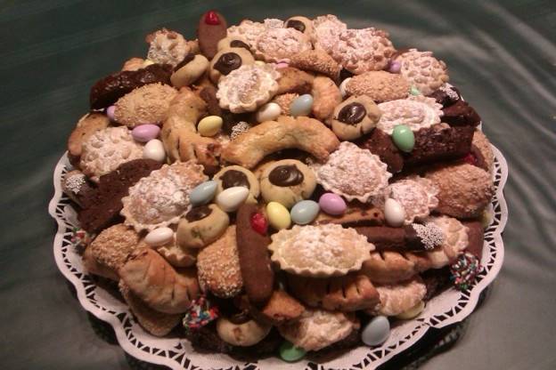 These are a Specialty Item to enhance the usual Sweet Table.  They are Italian Wedding Cookie Trays comprised of biscotti, Pignoli, Sesame Seed cookies, butter cookies rolled in pistachio nuts and topped with chocolate, Sicilian filled crescents, almond cookies and chocolate butter cookies.  Jordan almonds also added to the tray, are known as confetti.