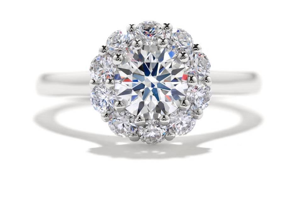<b>Beloved Diamond Engagement Ring</b><br>
A well placed halo of diamonds create a unique look that comes together for a spectacular display of light. Available in 18K white gold and platinum.</br>