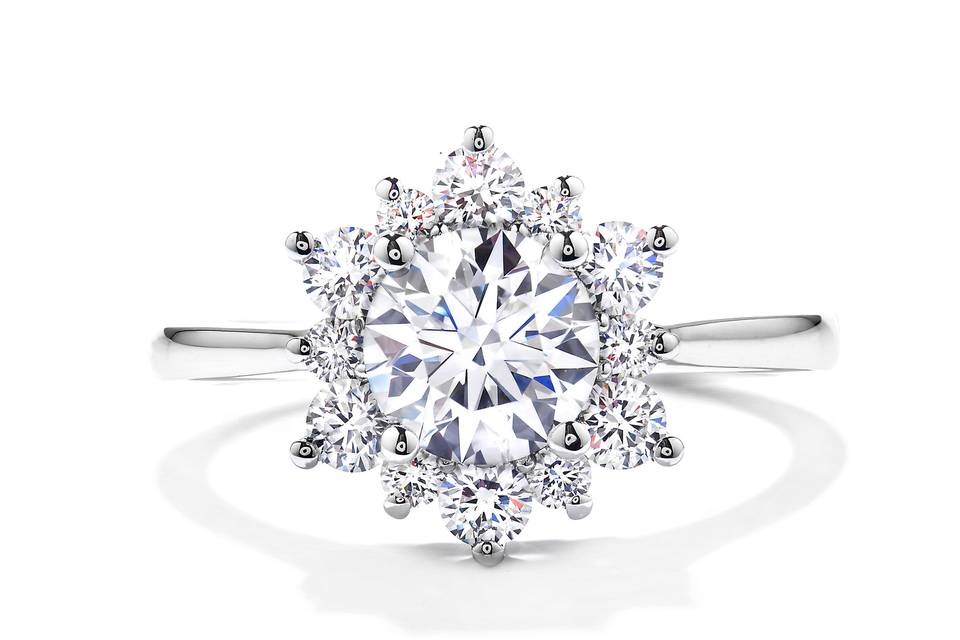Delight Lady Di Diamond Engagement Ring<br>
The perfect diamond engagement ring for the woman who wants simple but dazzling. A wreath of Hearts On Fire diamonds encircle the perfectly cut center diamond, creating a truly elegant and unique look.