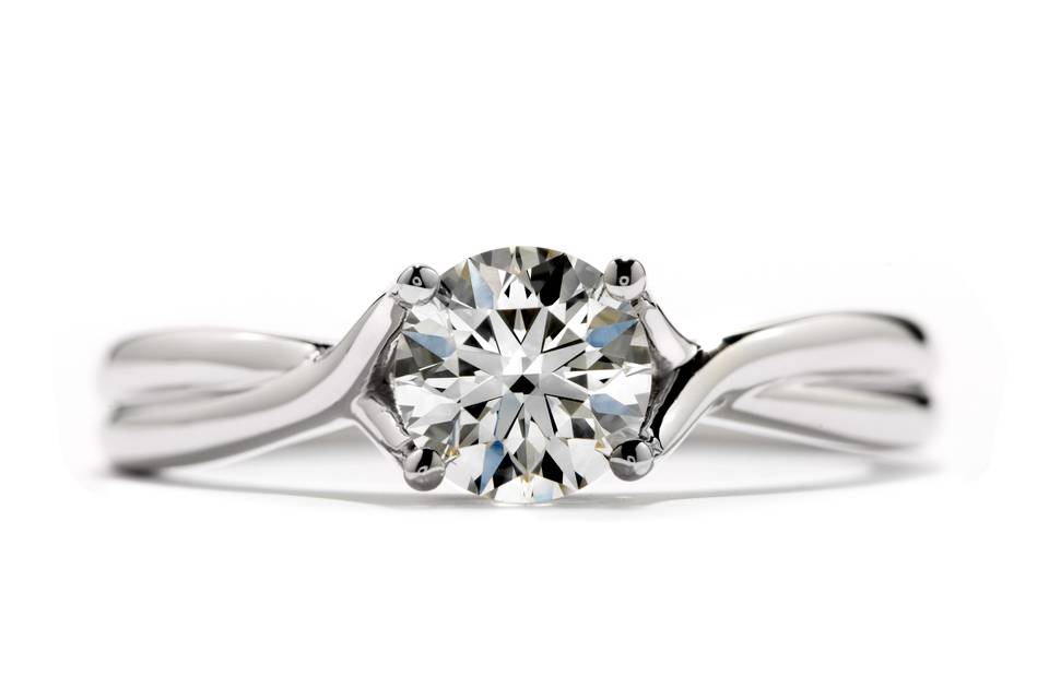 Simply Bridal Twist Solitaire Engagement Ring<br>
An elegant solitaire with a twist cradles The World's Most Perfectly Cut Hearts On Fire Diamond.