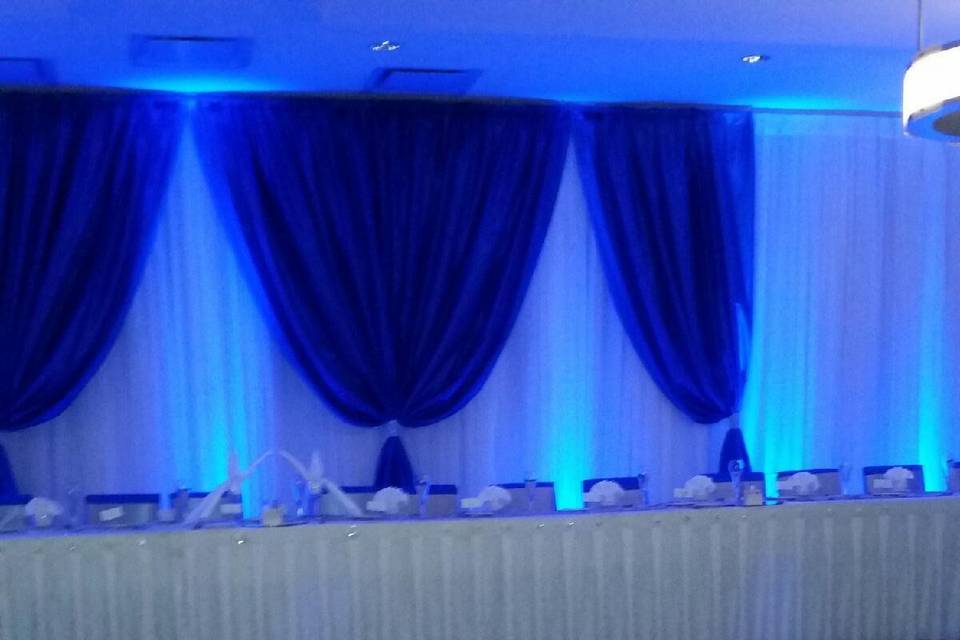 Custom Gobo on the dance floor. Blue and white drapes. Blue lighting.