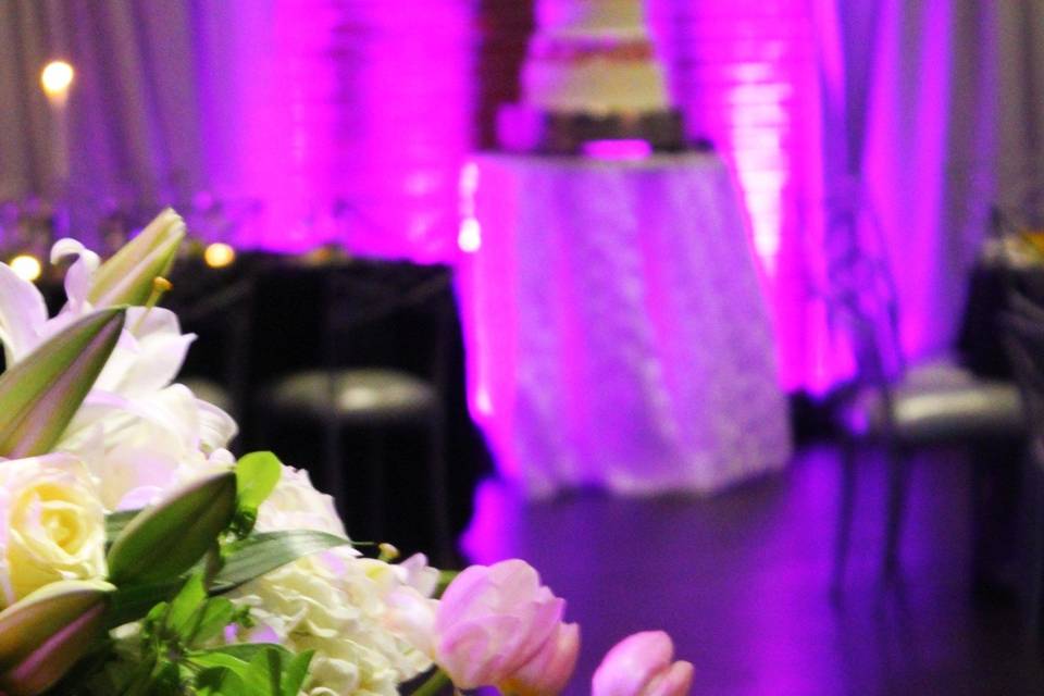Flowers, drape and lighting bring romance to an industrial space.