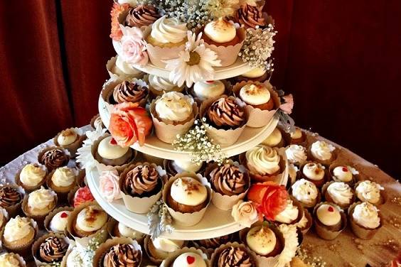 Cupcake tower with wedding cake on top