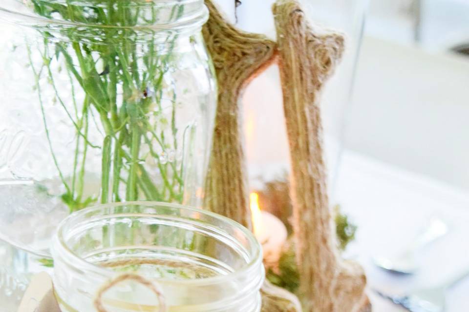 Rustic barn wedding with mason jar glasses. Centerpieces were simple and natural to fit the feel of the barn.