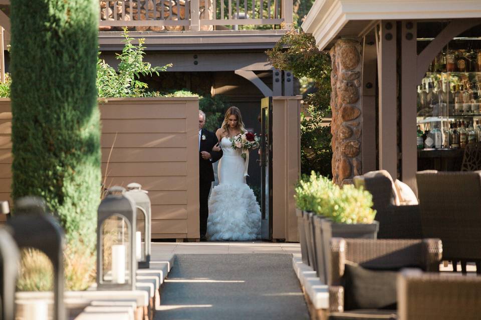 Bride being escorted  | Photo by c.m.elle studios Planning by Roque Events