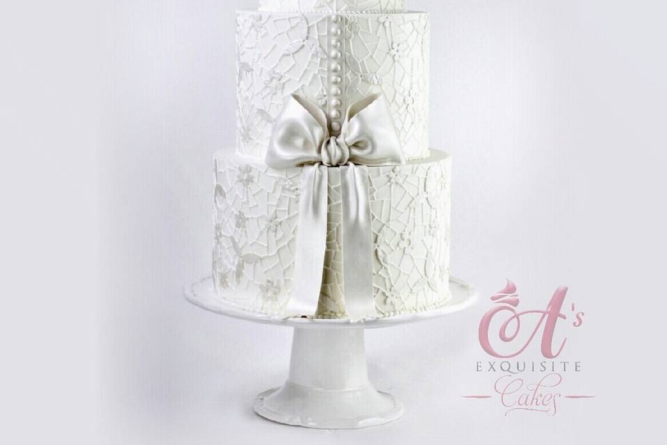 All white wedding cake with bow