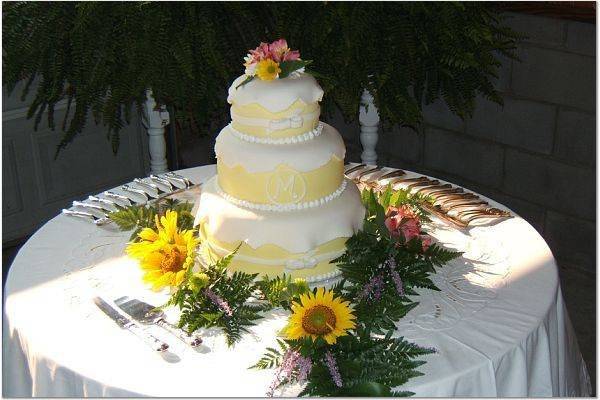 3 tier, round wedding cake covered w/ white & yellow fondant