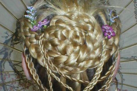 Five strand classic with multiple twists and a feathered bun.