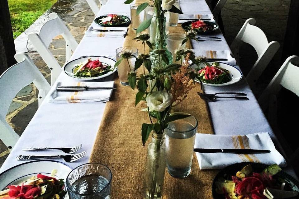 Another charming table set up with burlap runners, vintage bottles and elegant flatware for a mix and match shabby chic look.