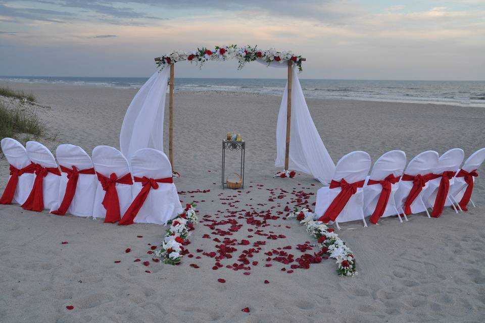 Www.CocoaBeachWeddings.com                               our bamboo arch with white and red accents.