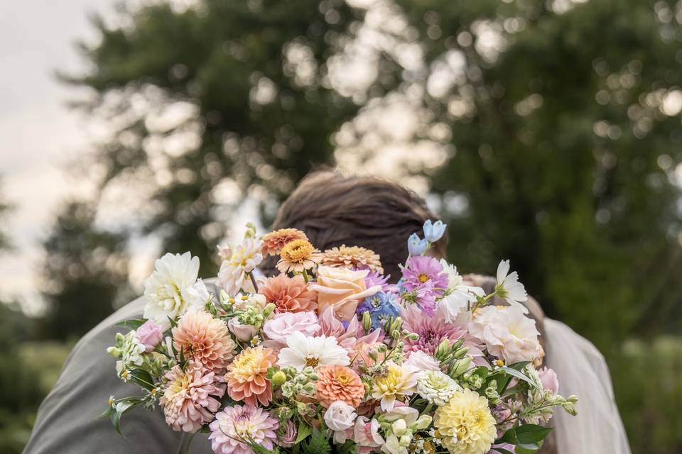 Kisses behind the boquet!