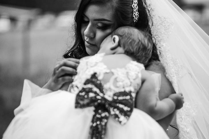 Bride holding her baby