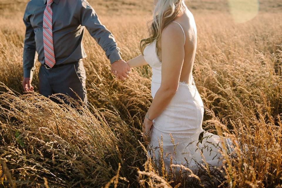 Bride and groom in field