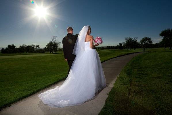 Bride and Groom walking down a path