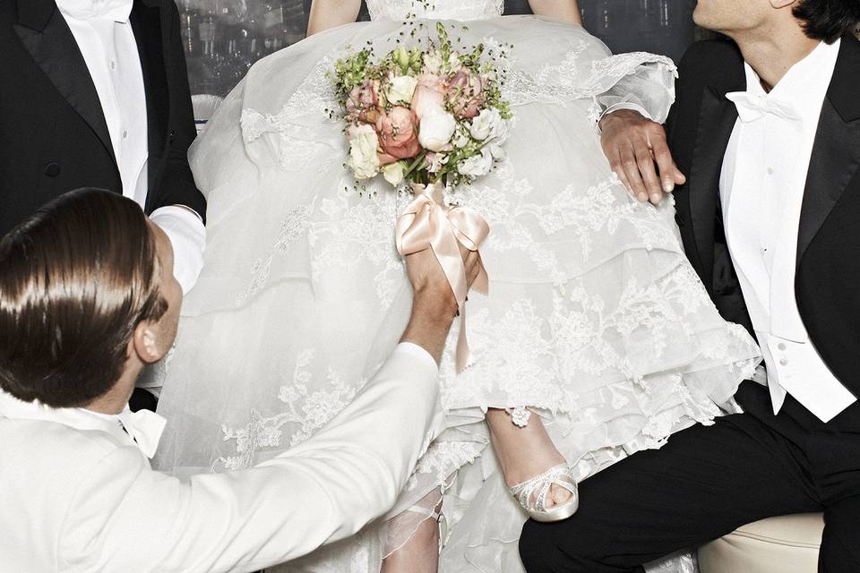 Groomsmen carrying bride