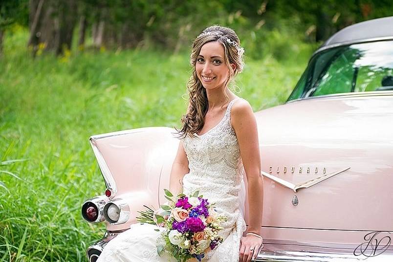 Bride sitting on her wedding car