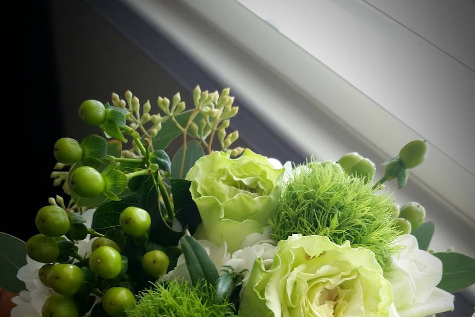 Elegant Bouquet of Green Cymbidium Orchids, Hypericum Berries, Green and White Roses and  Green Dianthus, something very unusual to add to make your bouquet stand out.