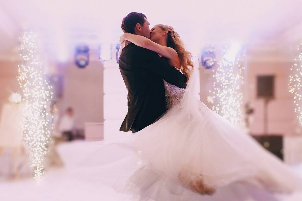 Groom holding up his bride