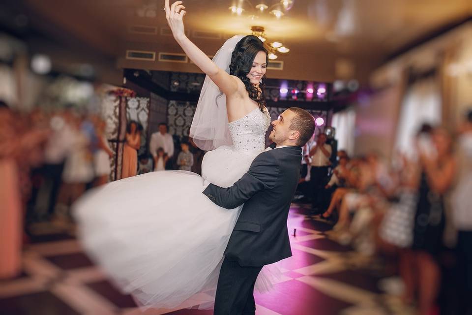 Groom holding up his bride