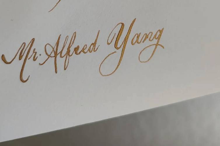 Gold calligraphy on white enve