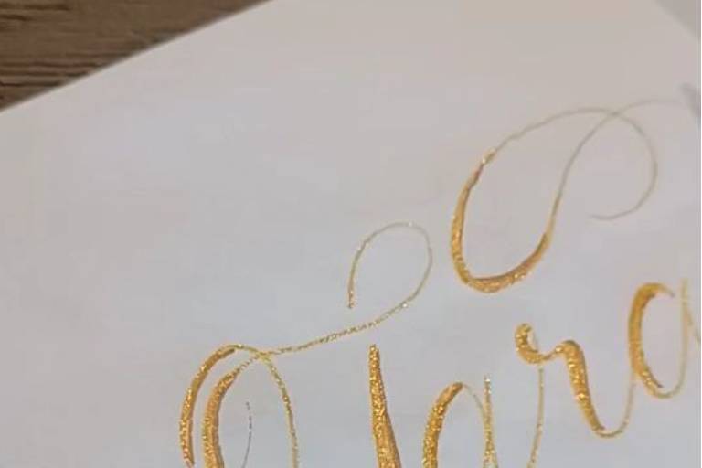 Gold calligraphy on white enve