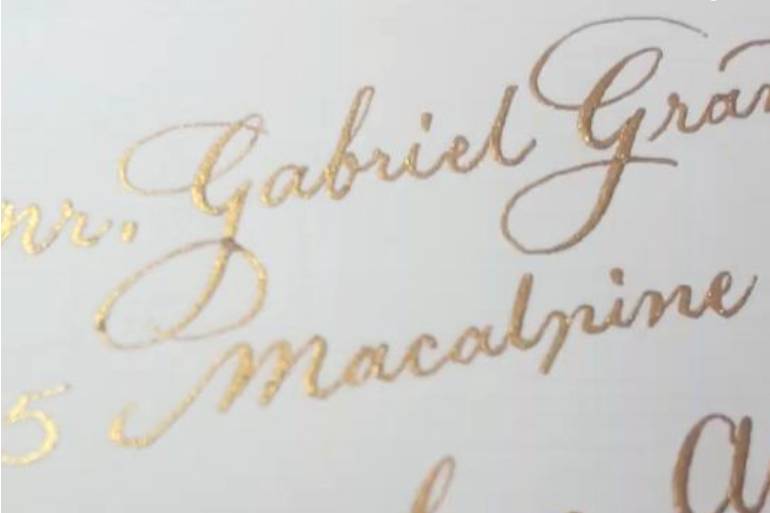 Gold calligraphy on white enve