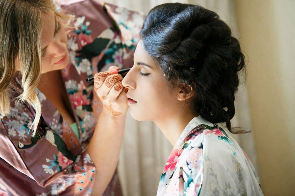 Applying makeup to the bride's face