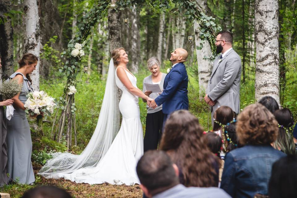 Exchanging vows beneath a leafy canopy