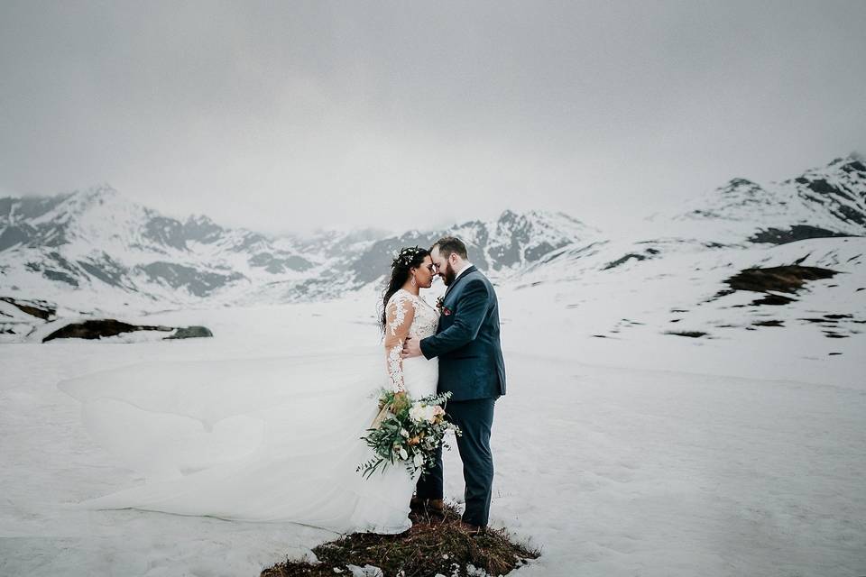 Newlyweds embrace in the snow