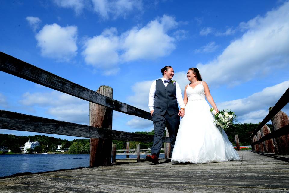 Couple walking hand in hand on dock - Russell's Photography Studio