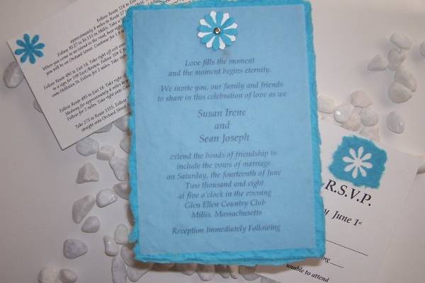 The Sky
Whether you’re having a seaside ceremony or a gorgeous, garden gathering this invitation will be sure to set the mood for your guests. The invitation is printed on a piece of delicate vellum and lays over a rich turquoise blue mulberry handmade paper. The vellum is attached to the mulberry paper with flower punches and a silver brad.