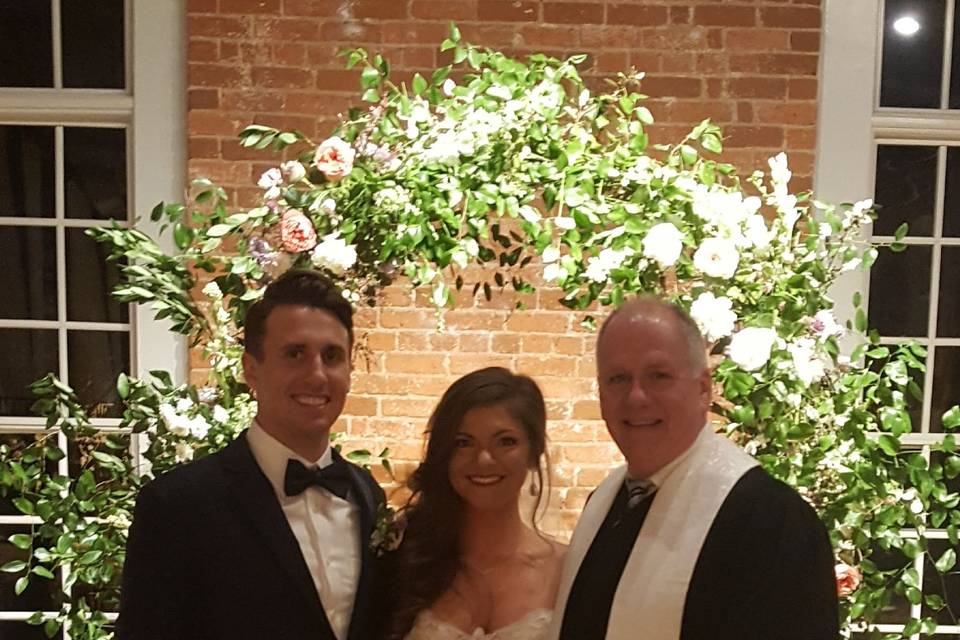 Lovely couple with officiant