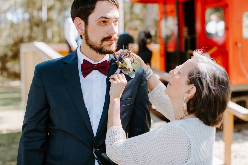 Mom pins his boutonniere