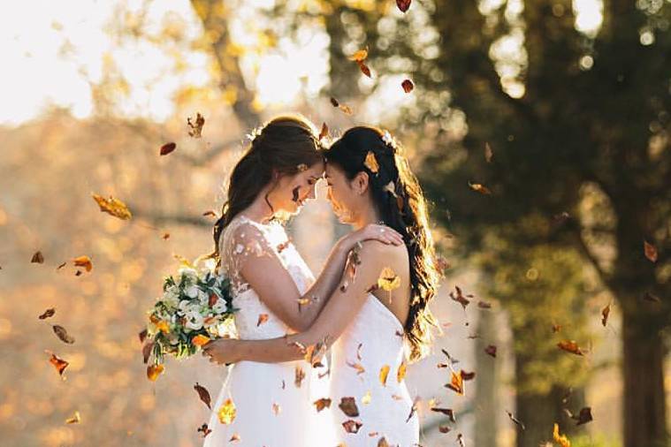 Brides holding each other