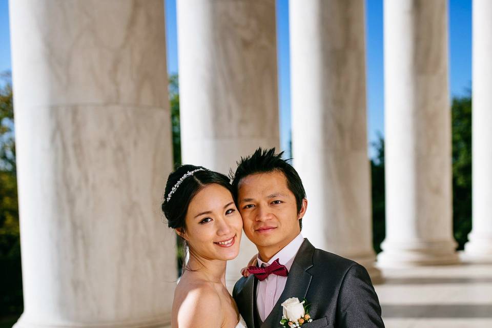 Newlyweds by the columns