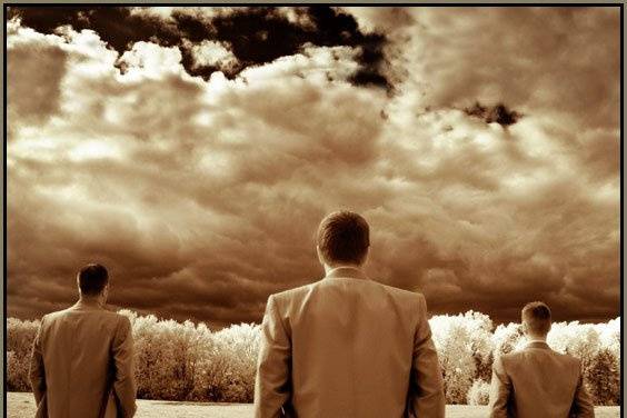 Groomsmen looking into the distance, cloudy.  Infrared image converted to sepia.