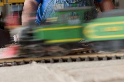 Groom candid in workshop with train set