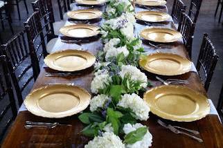 Gold chargers on farm table