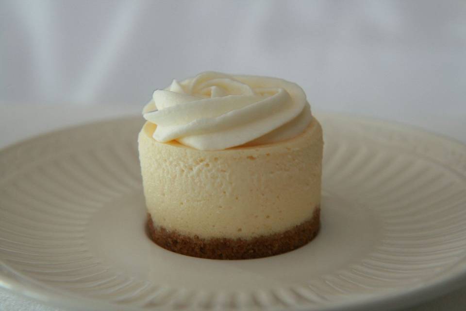 Amaretto Cheesecake - Creamy cheesecake blended with Amaretto Liqueur, topped with an almond butter cream and finished with a traditional crust.