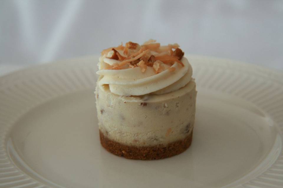 Italian Cream - Rich and Creamy Cheesecake filled with pecans and coconut, topped with a vanilla butter cream, toasted coconut and pecans and finished with a traditional crust