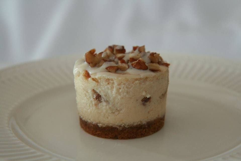 Cinnamon Roll Cheesecake - Creamy Cinnamon Cheesecake, with cinnamon, sugar and pecans swirled throughout, topped with a sweet cream glaze, finished with a cinnamon graham crust.