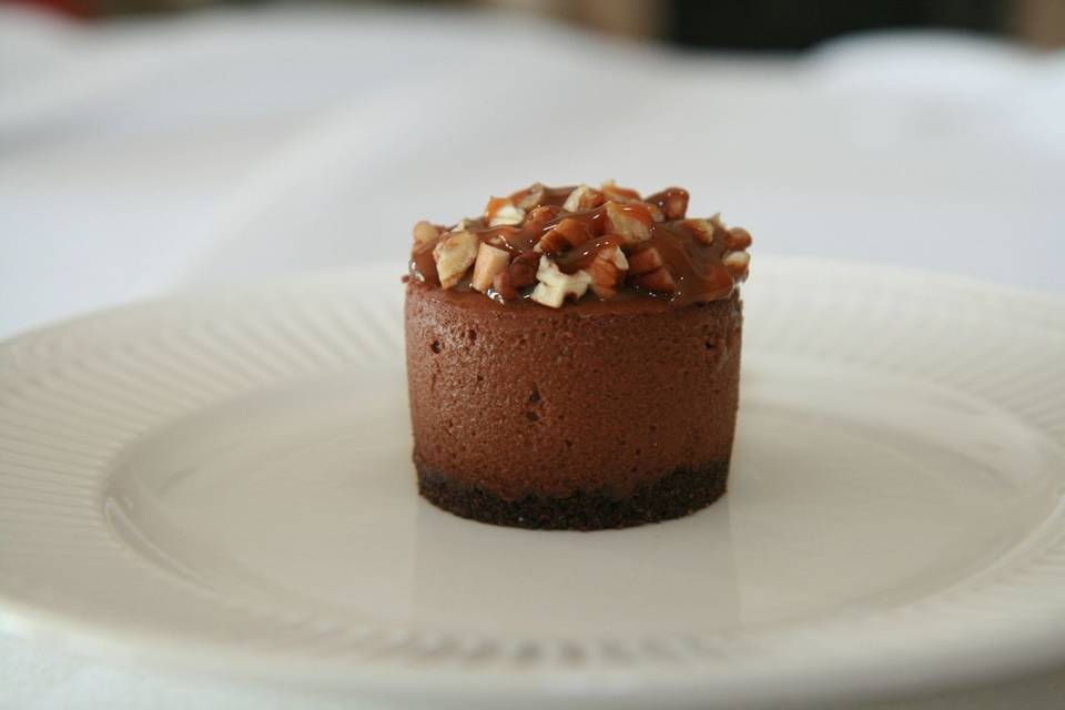 Chocolate Truffle Turtle Cheesecake - Creamy Rich Chocolate Truffle Cheesecake, topped with a mound of caramel and pecans, finished with a chocolate crust