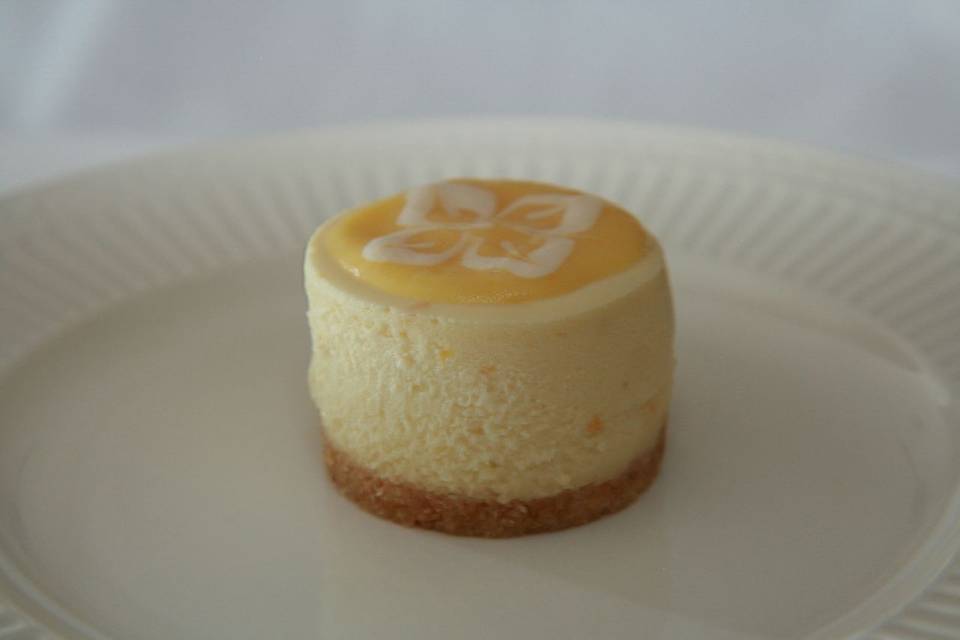 Triple Citrus Cheesecake - Creamy blend of Orange, Lemon and Lime, topped with Lemon Curd and finished with sweet cookie crust