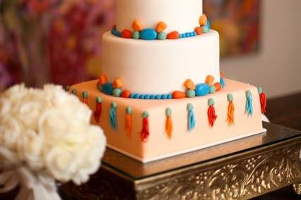 White three layered cake with colorful design